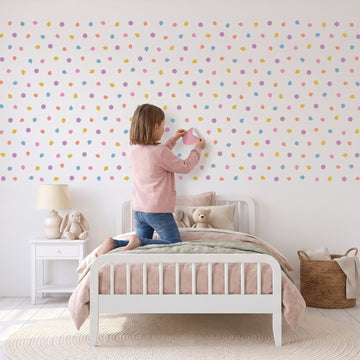 Pastel Pebble Dots Wall Sticker Decals wall decals: a girl putting the decals up in a girl's bedroom
