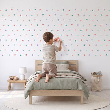 Starry Skies Wall Sticker Decals wall decals: a boy putting the decals up in a boy's bedroom