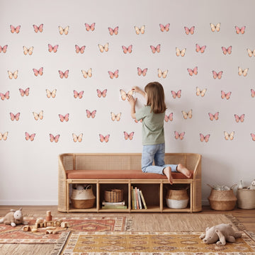 Blush Watercolour Butterflies Wall Sticker Decals wall decals: a girl putting the decals up in a playroom
