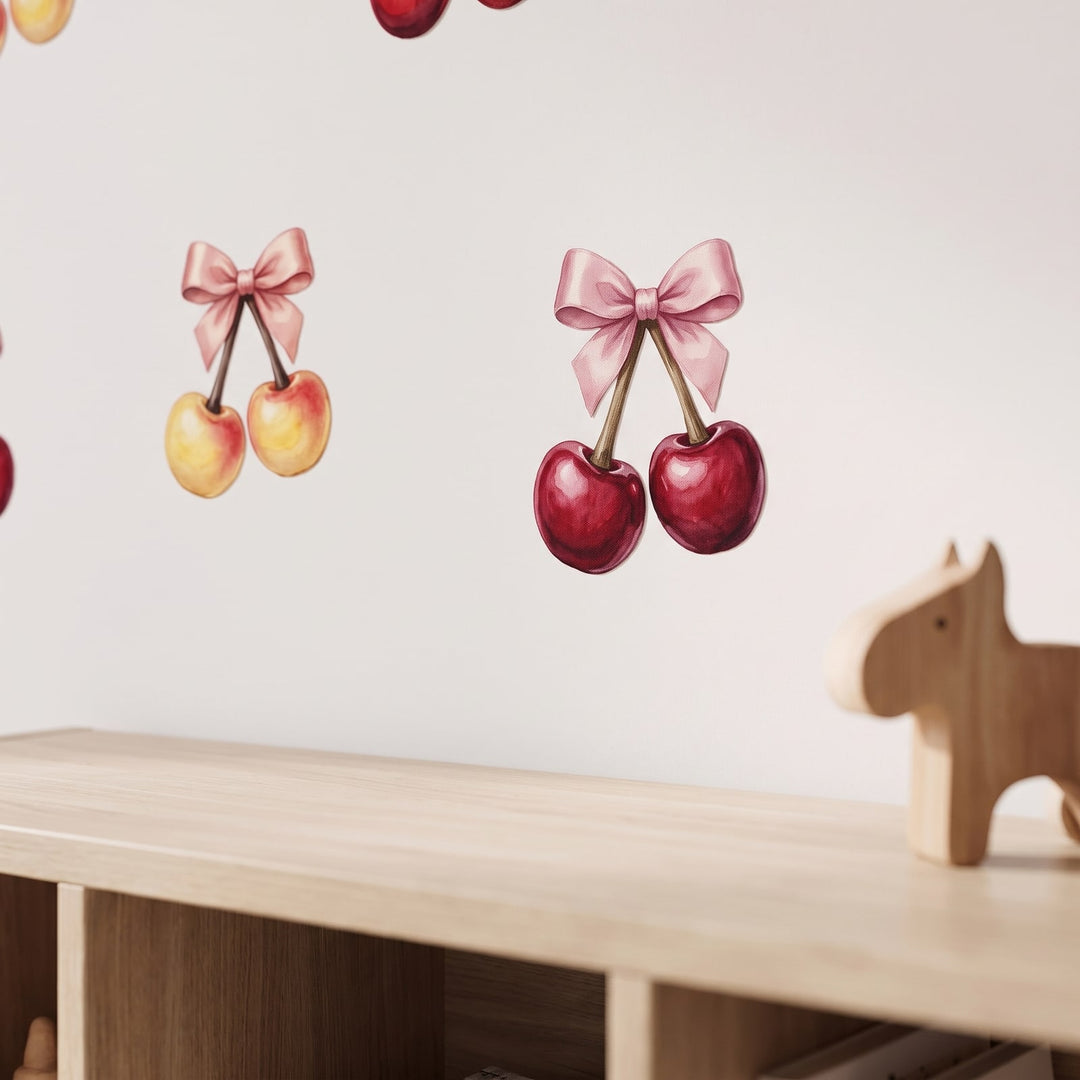 Cherries with Pink Bow Wall Sticker Decals wall decals: a close-up of the decals from one side in a kids' room