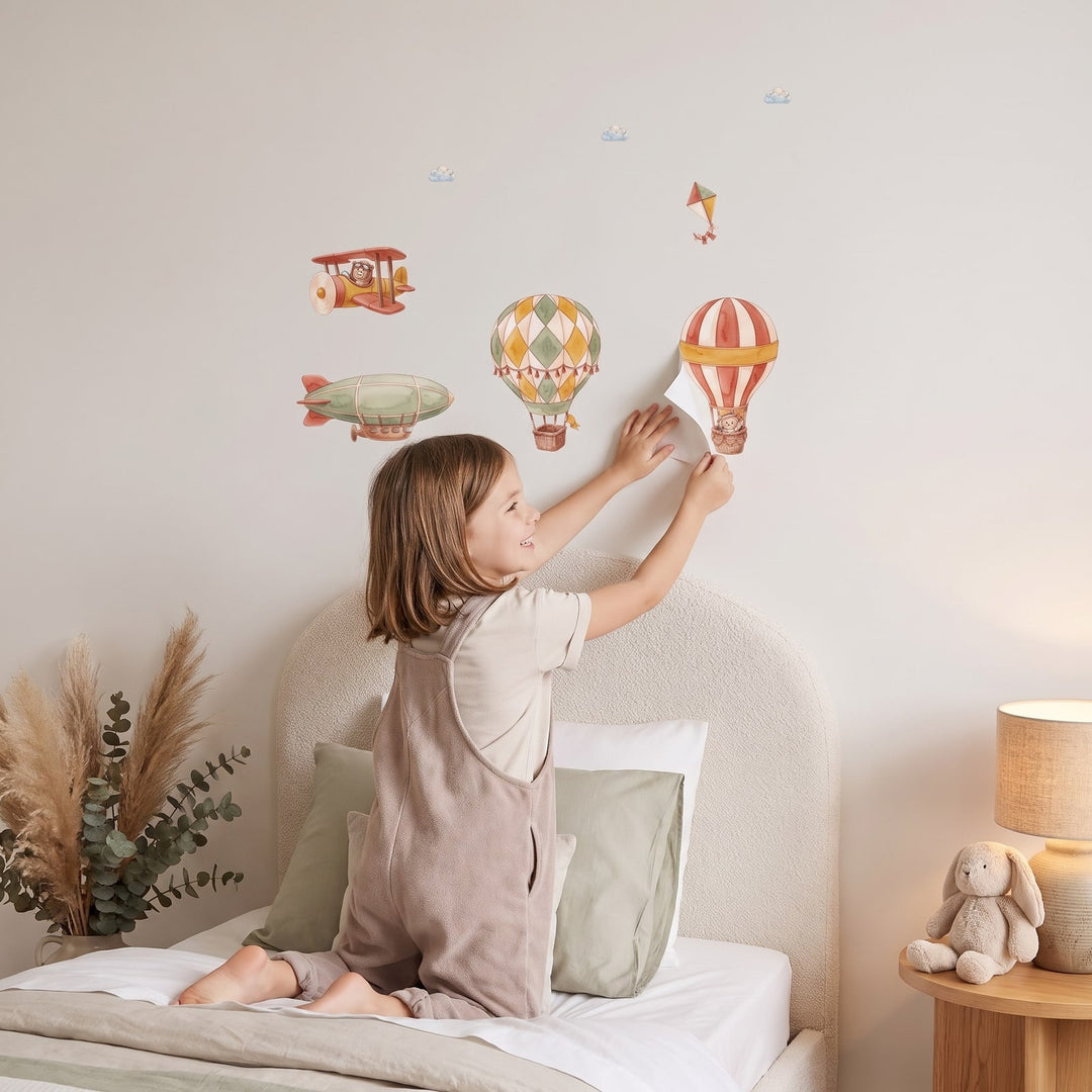 Patchwork Balloon Skies Wall Sticker Decals wall decals: a girl putting the decals up in a girl's bedroom