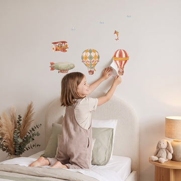 Patchwork Balloon Skies Wall Sticker Decals wall decals: a girl putting the decals up in a girl's bedroom