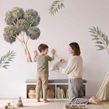 Ghost Gum Tree Wall Sticker Decals wall decals: a boy and his mum putting the decals up in a playroom