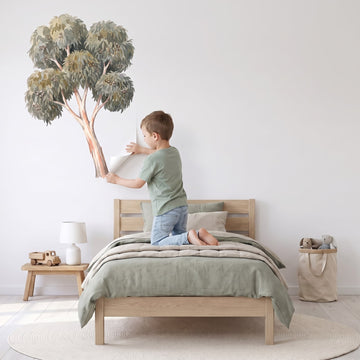 Ghost Gum Tree Wall Sticker Decals wall decals: a boy putting the decals up in a boy's bedroom