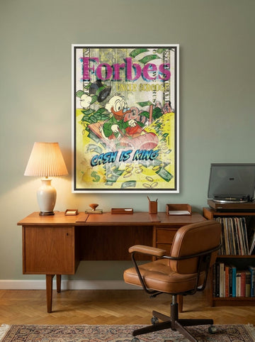 Canvas wall art with a white surround styled on the wall in a mid-century home office
