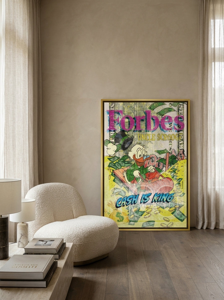Oversized statement canvas wall art with a gold leaf surround leaning against the wall in a luxe living room