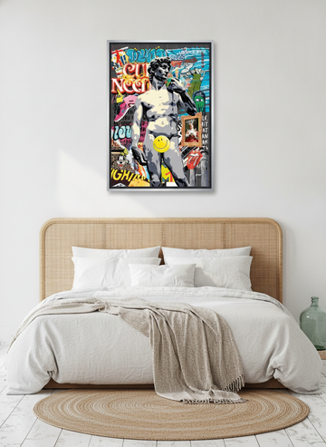 Canvas wall art with a silver leaf surround styled on the wall in a coastal bedroom