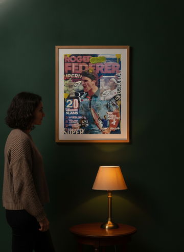 Person holding modern wall art print in a moody living room