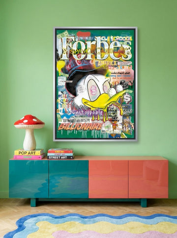 Canvas wall art with a silver leaf surround styled on the wall in a colourful eclectic living room