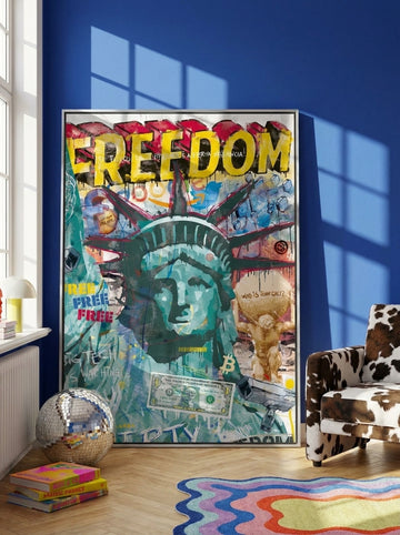 Oversized statement canvas wall art with a silver leaf surround leaning against the wall in a colourful eclectic living room