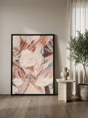 Oversized statement canvas wall art with a black surround leaning against the wall in a luxe living room