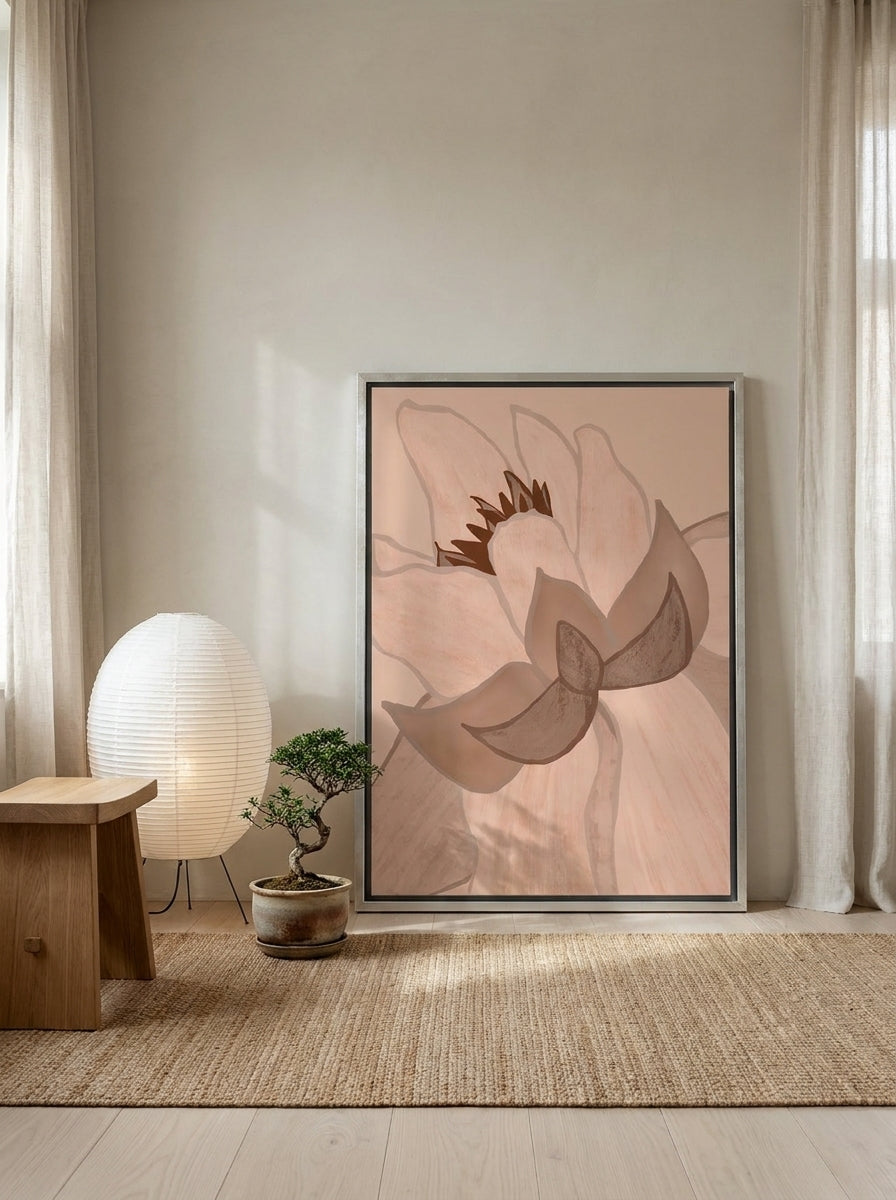 Canvas wall art with a silver leaf surround leaning against the wall in a warm Japandi bathroom