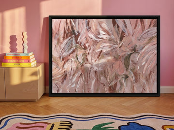 Canvas wall art with a black surround standing on a sideboard in a colourful eclectic living room