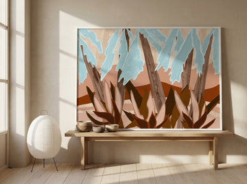 Modern wall art print standing on a bench in a warm Japandi bedroom