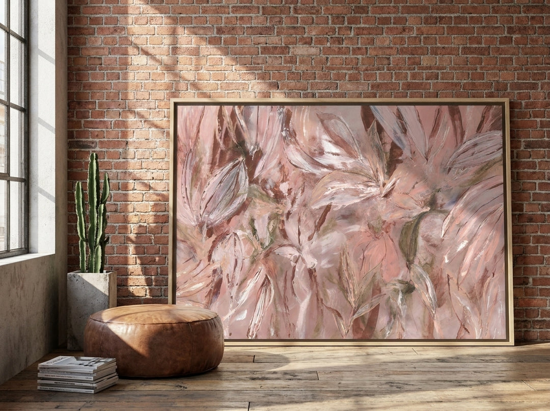 Oversized statement canvas wall art with a natural timber surround leaning against the wall in an industrial loft dining room