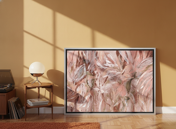 Canvas wall art with a silver leaf surround leaning against the wall in a retro 70s dining room