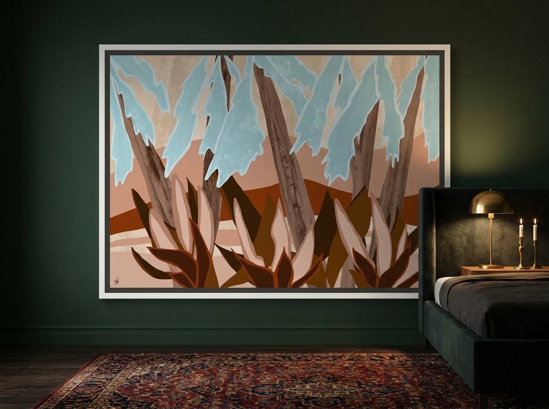 Canvas wall art with a white surround styled on the wall in a moody bedroom