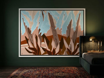 Canvas wall art with a white surround styled on the wall in a moody bedroom