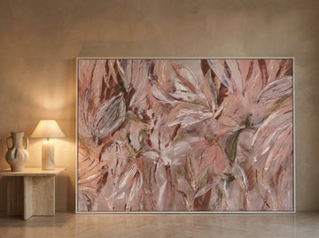 Oversized statement modern wall art print leaning against the wall in a luxe living room