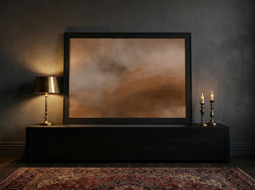 Modern wall art print standing on a console in a moody living room