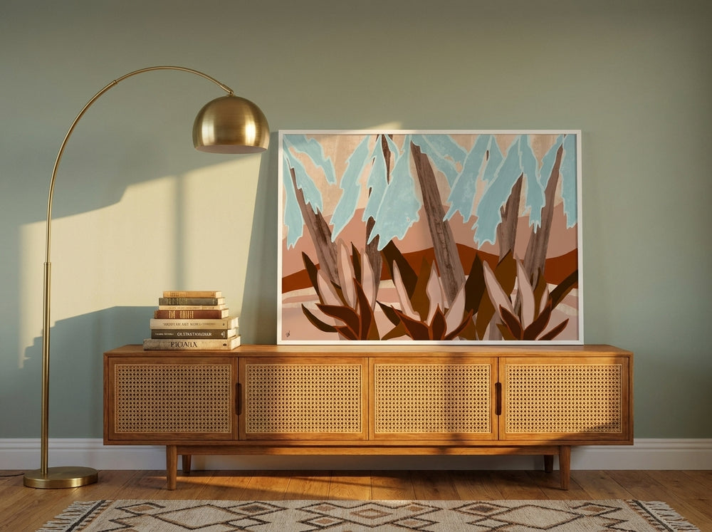 Modern wall art print standing on a sideboard in a mid-century home office