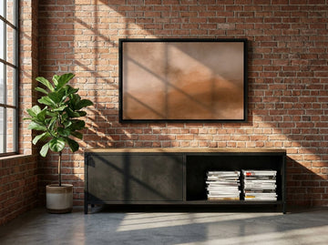 Canvas wall art with a black surround styled on the wall in an industrial loft living room