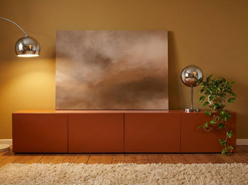 Stretched canvas wall art standing on a sideboard in a retro 70s home office