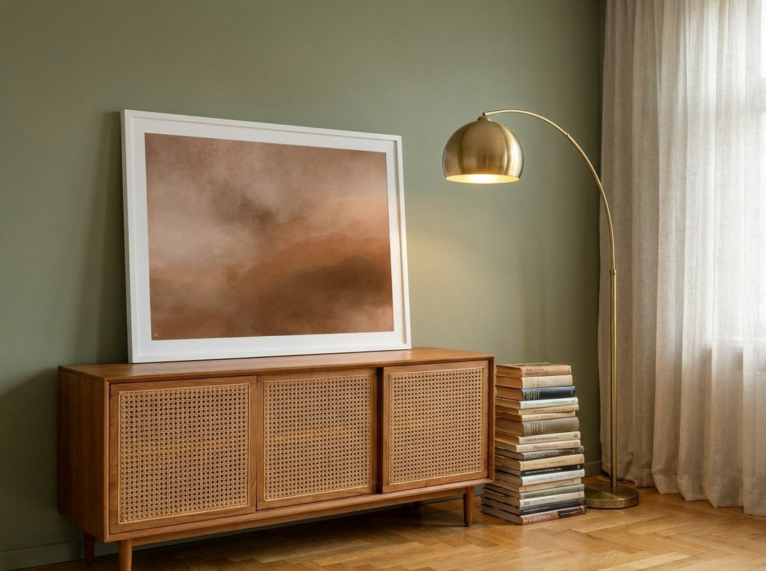 Modern wall art print standing on a sideboard in a mid-century home office