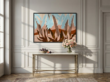 Canvas wall art with a black surround styled on the wall in a Parisian living room