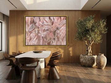 Oversized statement canvas wall art with a gold leaf surround styled on the wall in a luxe dining room
