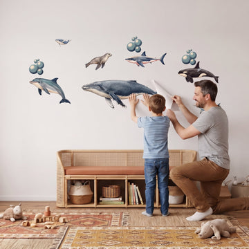 Under the Sea Wall Sticker Decals wall decals: a boy and his dad putting the decals up in a playroom