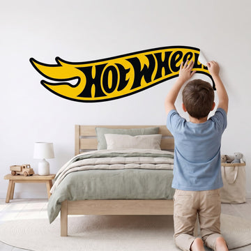 Hot Wheels Black & Yellow Logo Wall Sticker Decals wall decals: a boy putting the decals up in a boy's bedroom