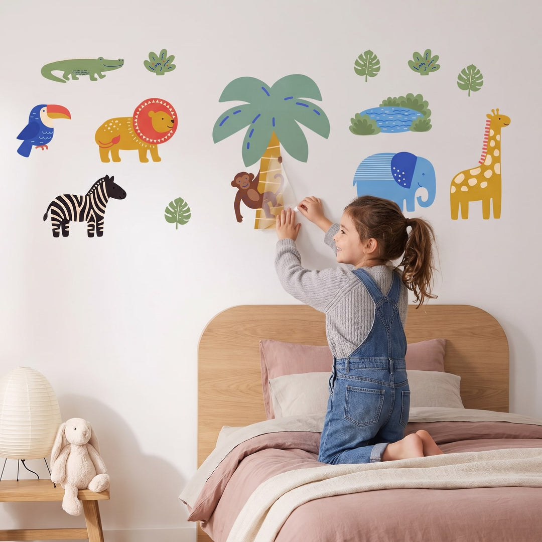 Cut Paper Safari Set Wall Sticker Decals wall decals: a girl putting the decals up in a girl's bedroom