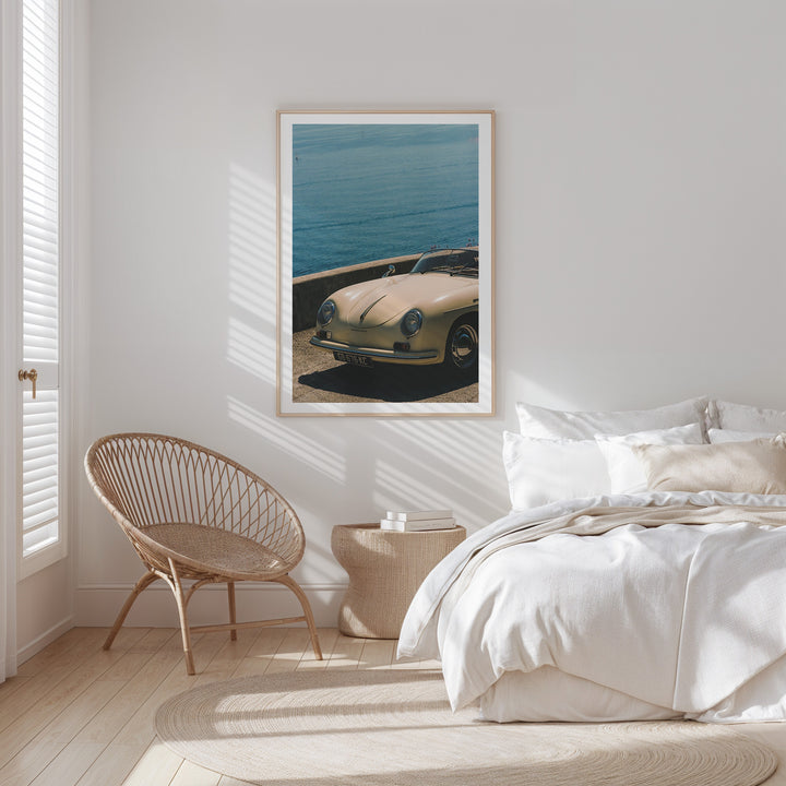 coastal bed with photo of white care on wall