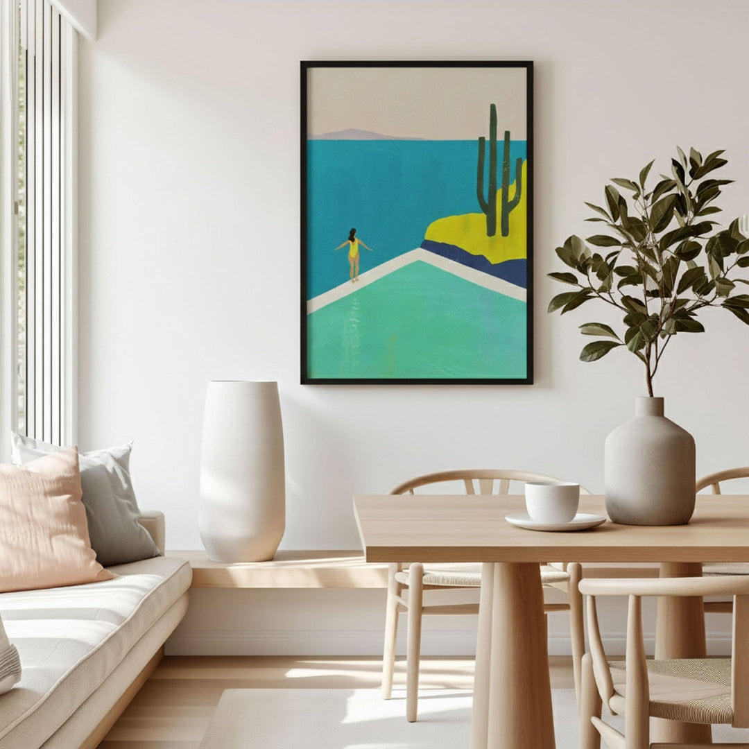 Modern living room with an artwork of a desert scene, a table with a plant, and a couch.