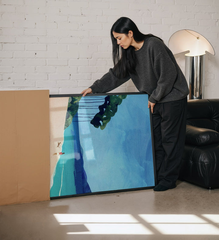 Woman standing next to a large abstract painting in a modern living room.