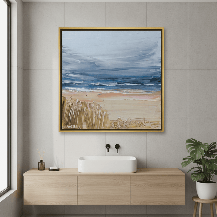 Canvas wall art with a gold leaf surround styled in a clean minimalist bathroom