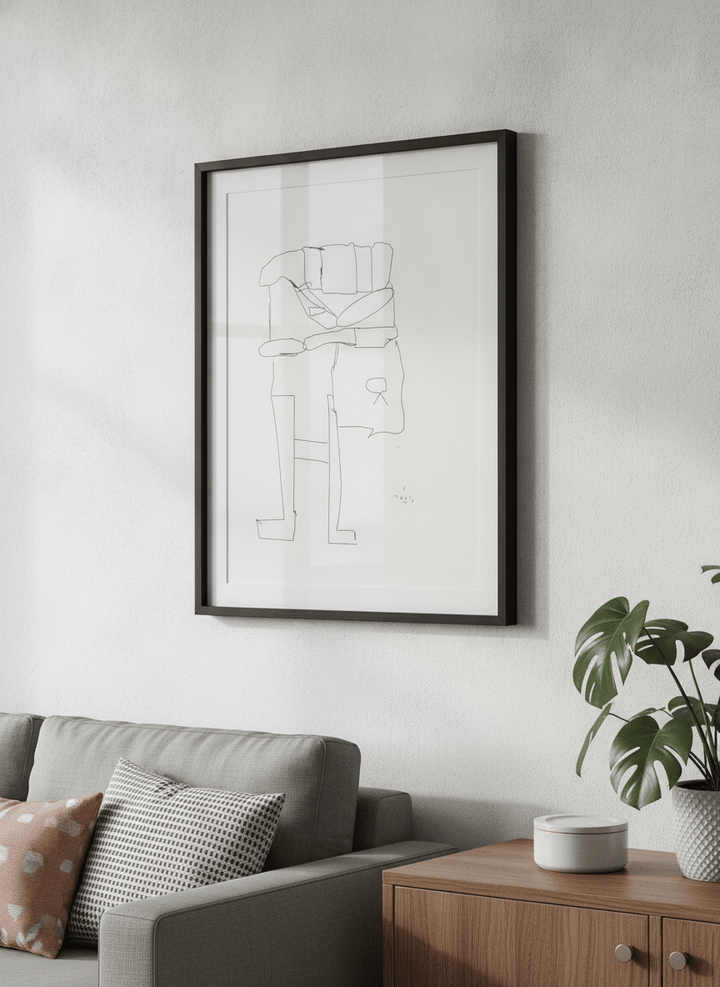 Modern wall art styled above a sofa in a neutral living room