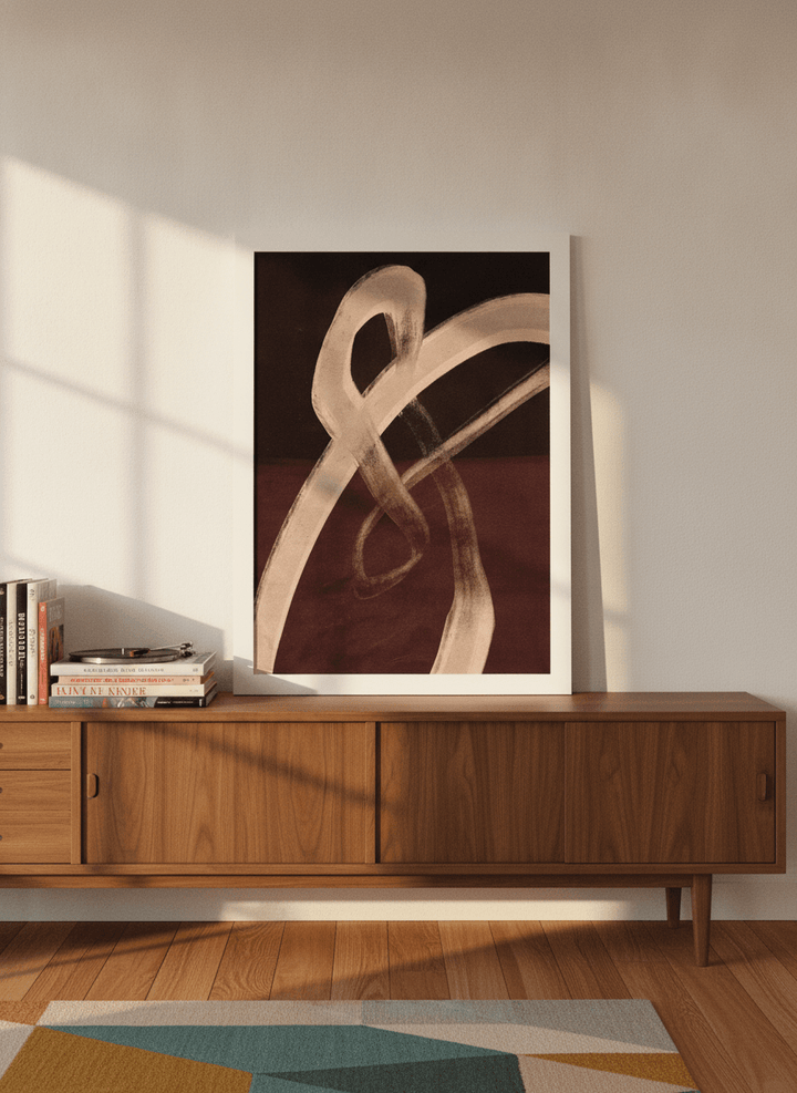 Modern wall art print standing on a sideboard in a mid-century bedroom