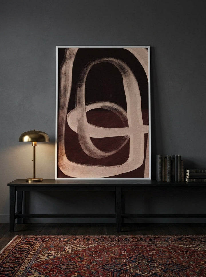 Modern wall art print standing on a console in a moody home office
