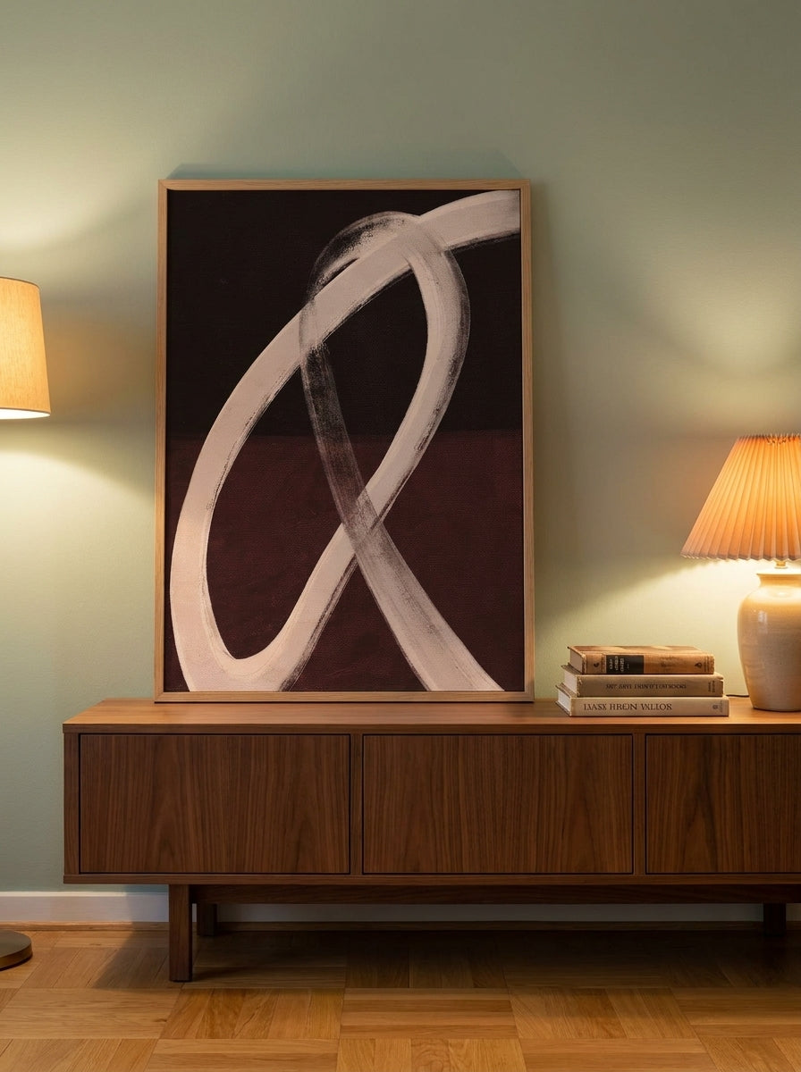 Modern wall art print standing on a sideboard in a mid-century bedroom