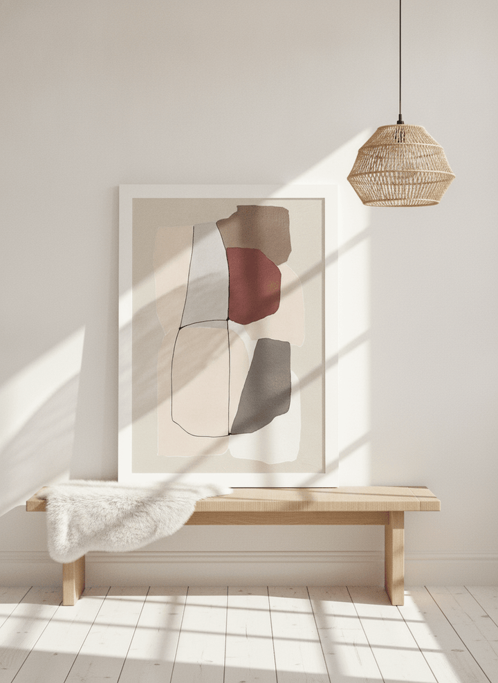 Modern wall art print standing on a bench in a bright Scandinavian home office