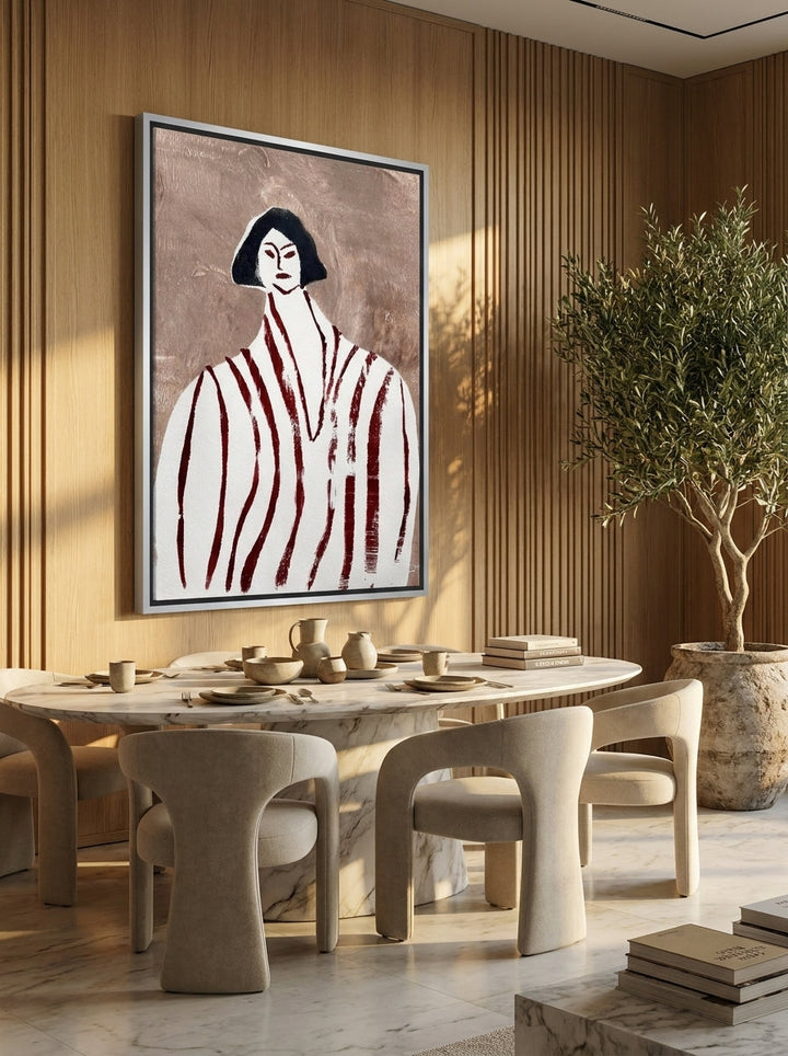 Oversized statement canvas wall art with a silver leaf surround styled on the wall in a luxe dining room