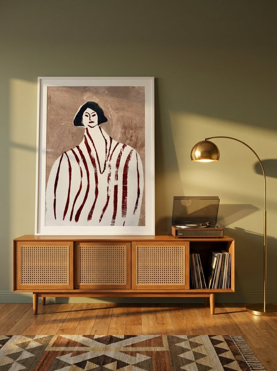 Modern wall art print standing on a sideboard in a mid-century home office