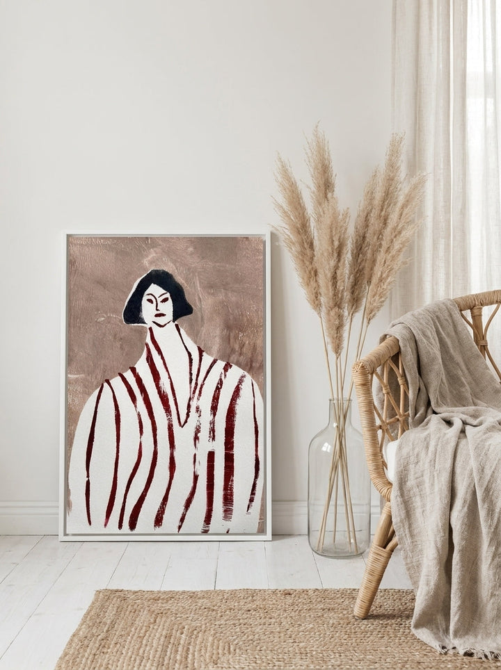 Canvas wall art with a white surround leaning against the wall in a coastal bedroom