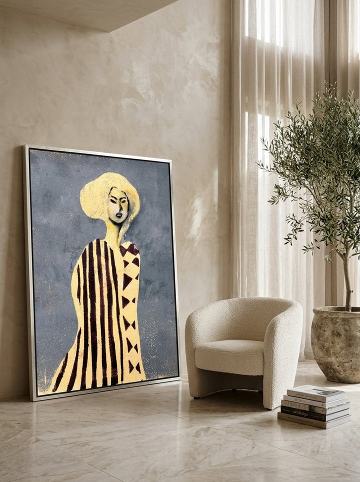 Oversized statement canvas wall art with a silver leaf surround leaning against the wall in a luxe dining room