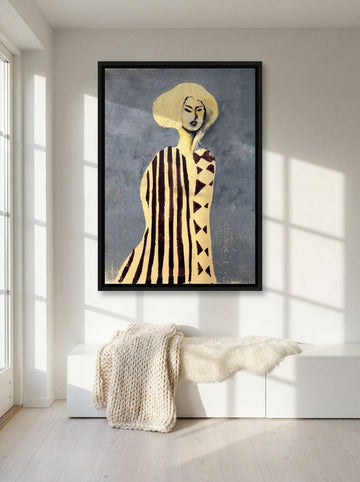 Canvas wall art with a black surround styled on the wall in a bright Scandinavian living room