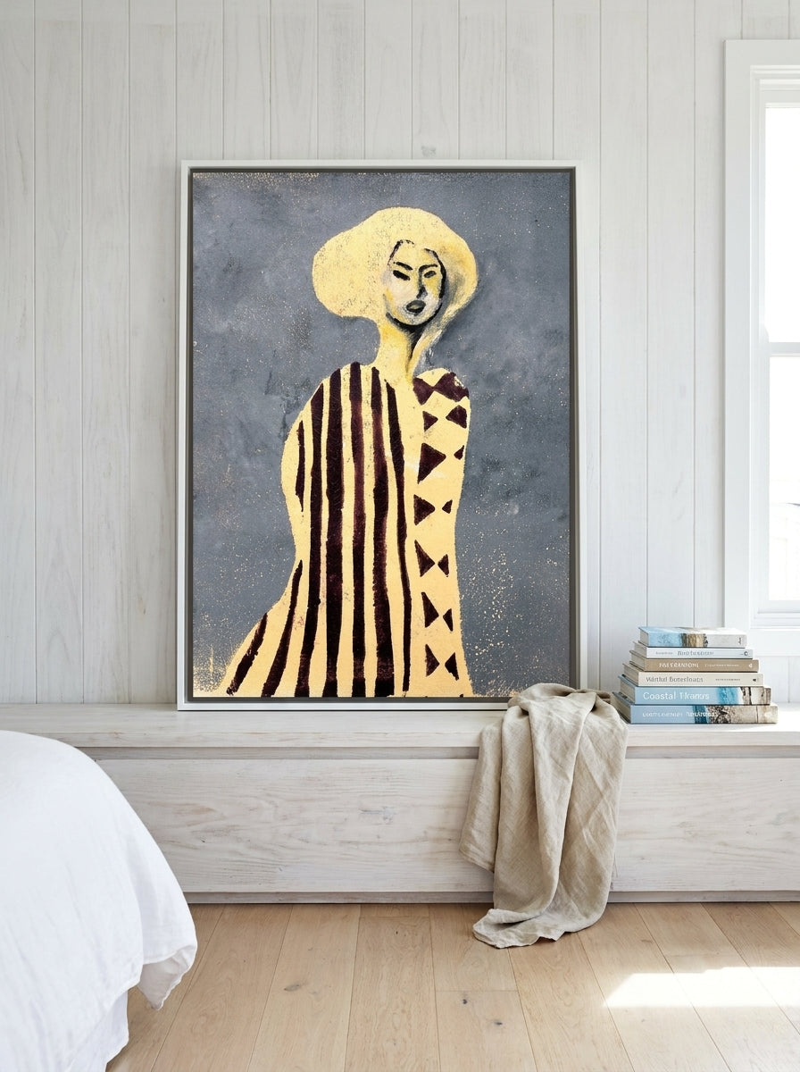 Canvas wall art with a white surround standing on a console in a coastal bedroom