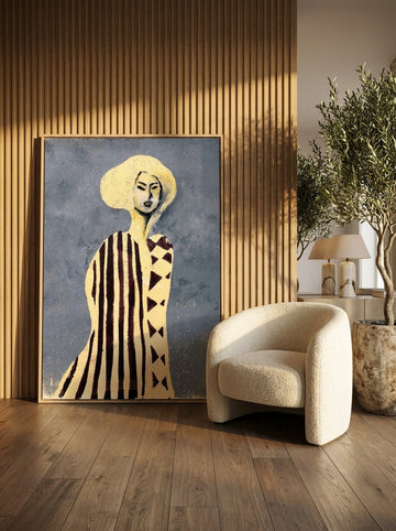 Oversized statement canvas wall art with a natural timber surround leaning against the wall in a luxe dining room
