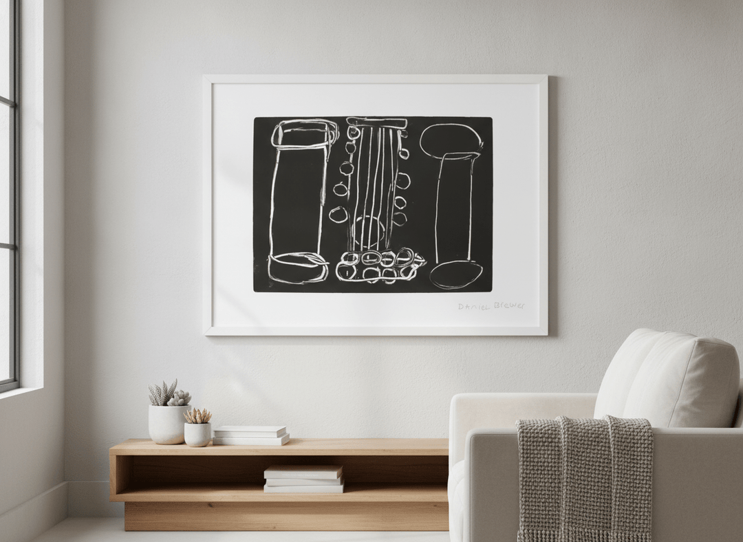 Modern wall art styled above a sofa in a neutral living room